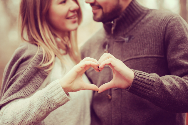 loving couple showing heart for valentine day on cozy walk